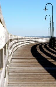 old wooden pier with old lamposts in the late afternoon